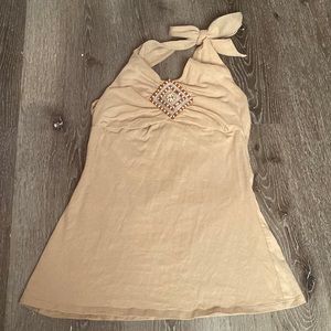 beige colored shirt. beaded in the middle